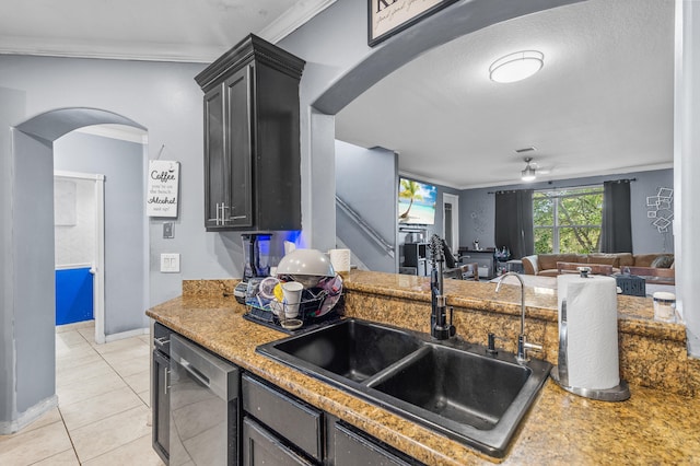 kitchen with arched walkways, ceiling fan, a sink, stainless steel dishwasher, and ornamental molding