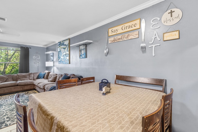 dining room featuring visible vents and crown molding