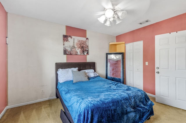 carpeted bedroom featuring ceiling fan, a closet, visible vents, and baseboards