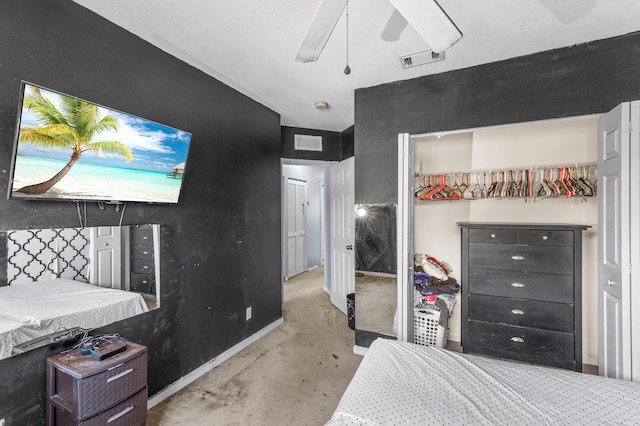 bedroom with concrete flooring, a closet, visible vents, and a ceiling fan