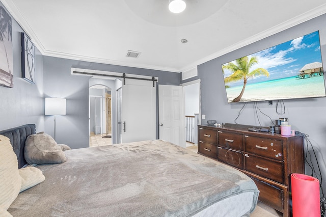 bedroom featuring ornamental molding, a barn door, arched walkways, and visible vents