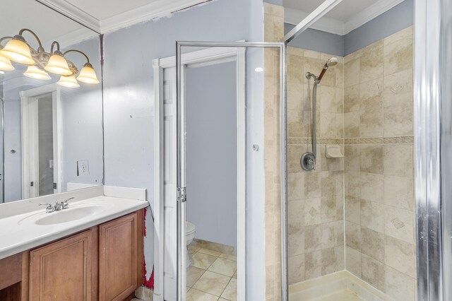 bathroom featuring toilet, vanity, tile patterned floors, a stall shower, and crown molding