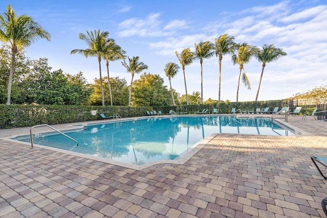 community pool featuring a patio and fence