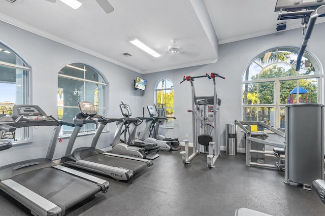 gym with a ceiling fan, visible vents, crown molding, and baseboards