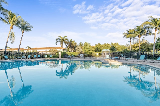 community pool featuring a patio area and fence