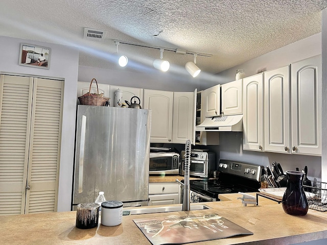 kitchen with visible vents, under cabinet range hood, a textured ceiling, appliances with stainless steel finishes, and white cabinets