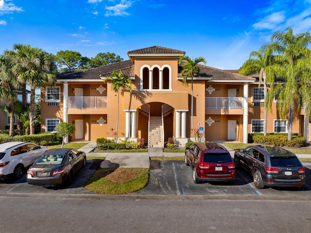 view of building exterior featuring uncovered parking