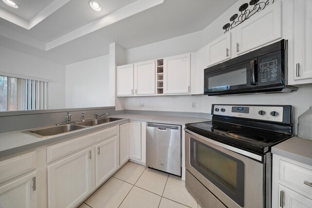 kitchen with a sink, open shelves, stainless steel appliances, white cabinets, and light tile patterned floors