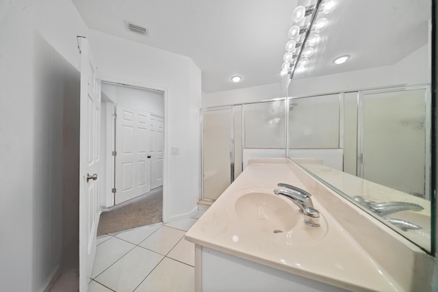 bathroom featuring vanity, baseboards, visible vents, and tile patterned flooring