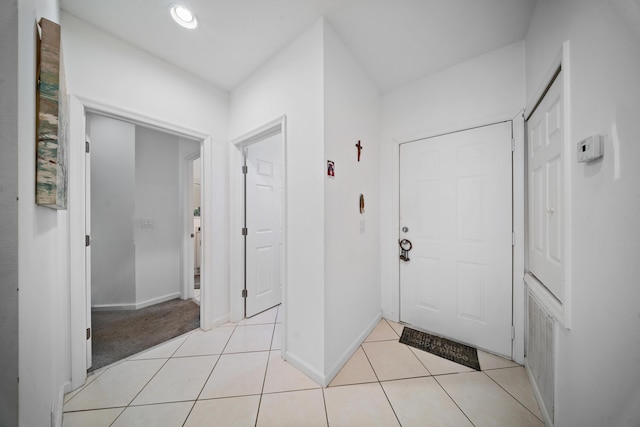 entryway featuring light tile patterned floors, baseboards, and recessed lighting