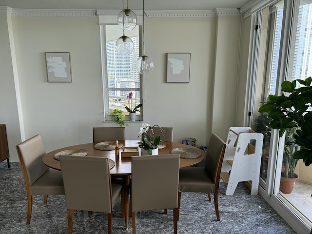 dining space with ornamental molding