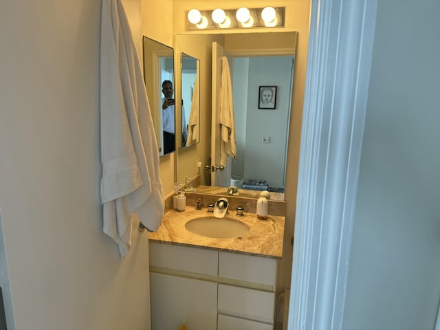 bathroom featuring toilet and vanity