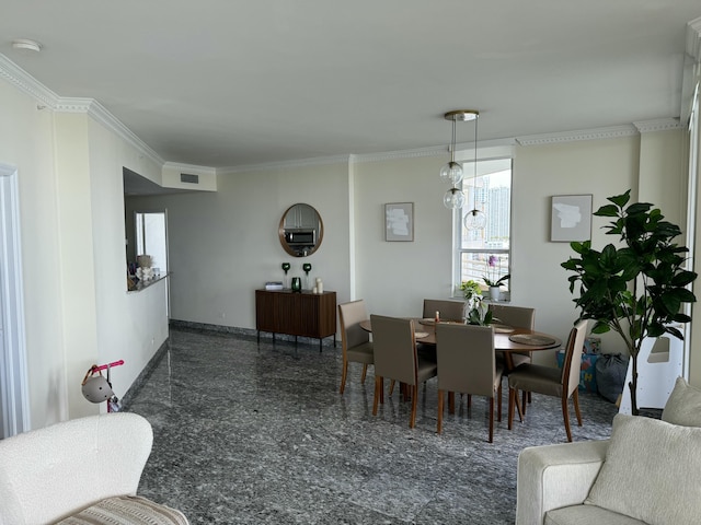 dining room with baseboards, granite finish floor, visible vents, and crown molding