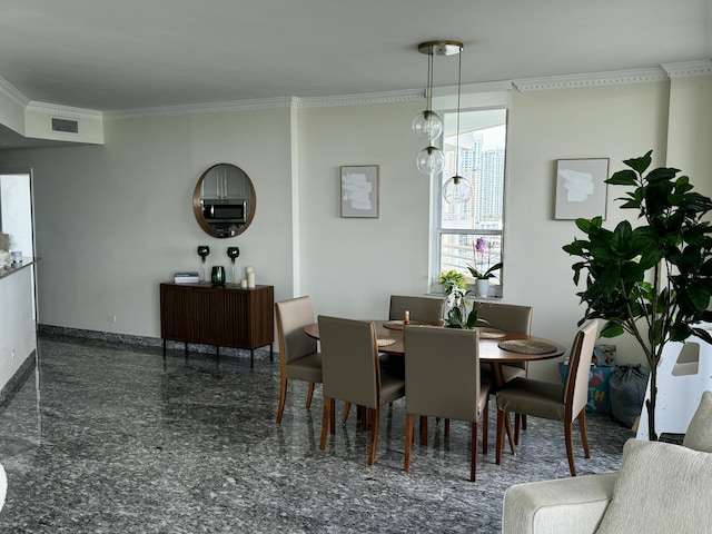 dining room with ornamental molding, granite finish floor, visible vents, and baseboards