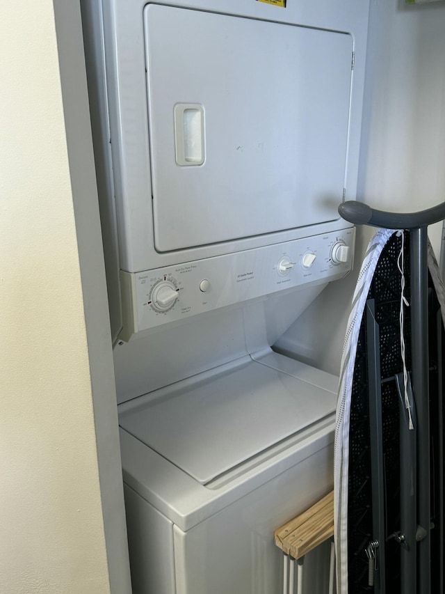 laundry area with stacked washer / dryer and laundry area