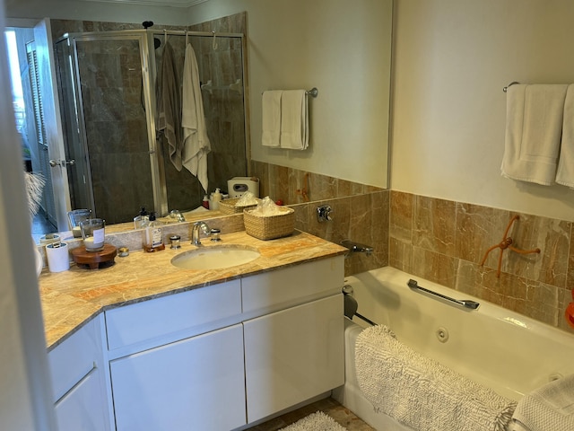 full bath featuring a whirlpool tub, a shower stall, and vanity