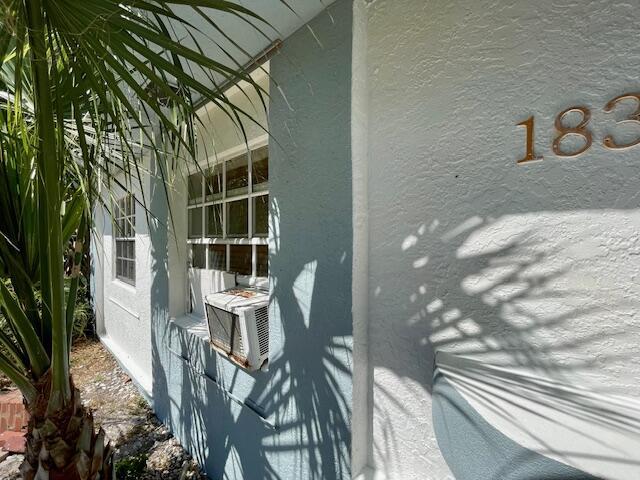 view of home's exterior with stucco siding and cooling unit