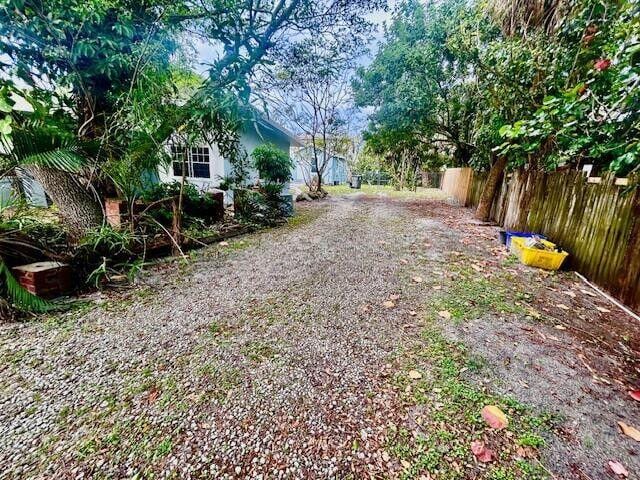 view of street featuring gravel driveway