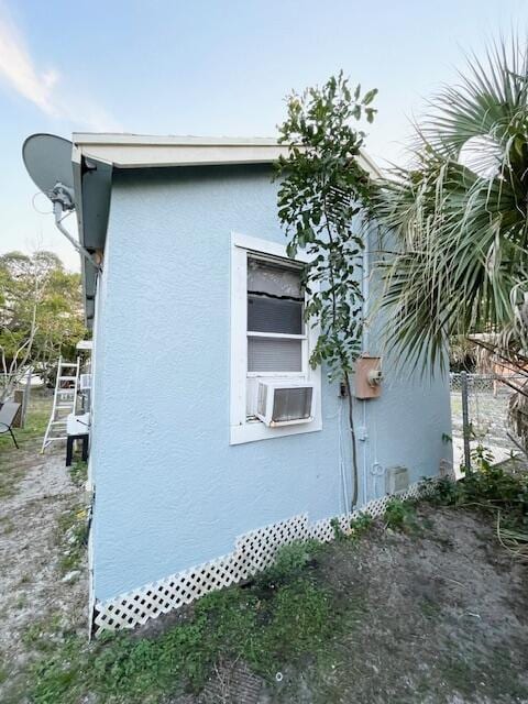 1831 Juno Rd Unit 123, North Palm Beach, FL 33408 - view of home's exterior featuring stucco siding and cooling unit