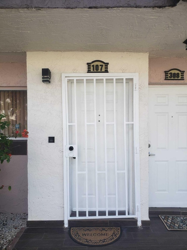 doorway to property with stucco siding