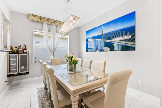 dining area featuring baseboards, wine cooler, a notable chandelier, and marble finish floor