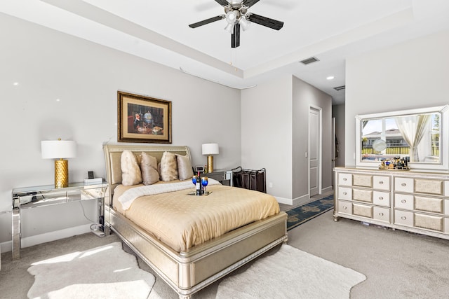 carpeted bedroom with visible vents, ceiling fan, baseboards, recessed lighting, and a raised ceiling