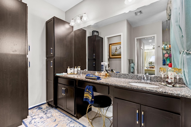 full bathroom featuring double vanity, visible vents, and a sink