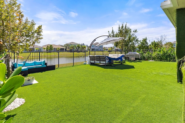 view of yard featuring fence and a water view