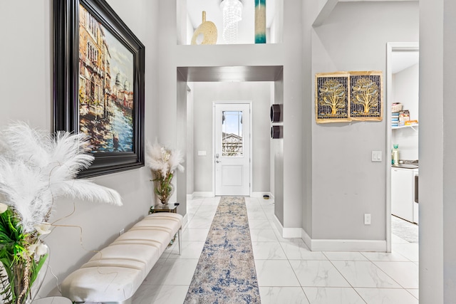 entrance foyer featuring marble finish floor and baseboards