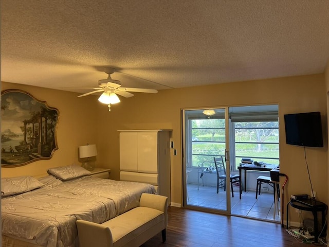 bedroom with dark wood-style flooring, a textured ceiling, a ceiling fan, and access to outside