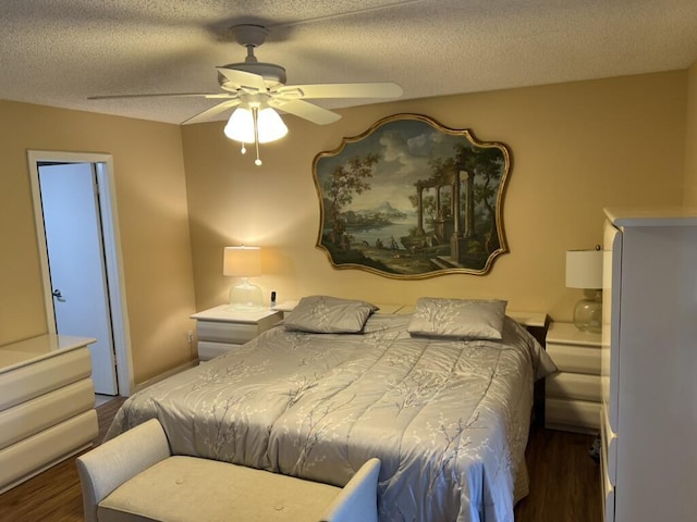 bedroom with a textured ceiling, ceiling fan, and wood finished floors