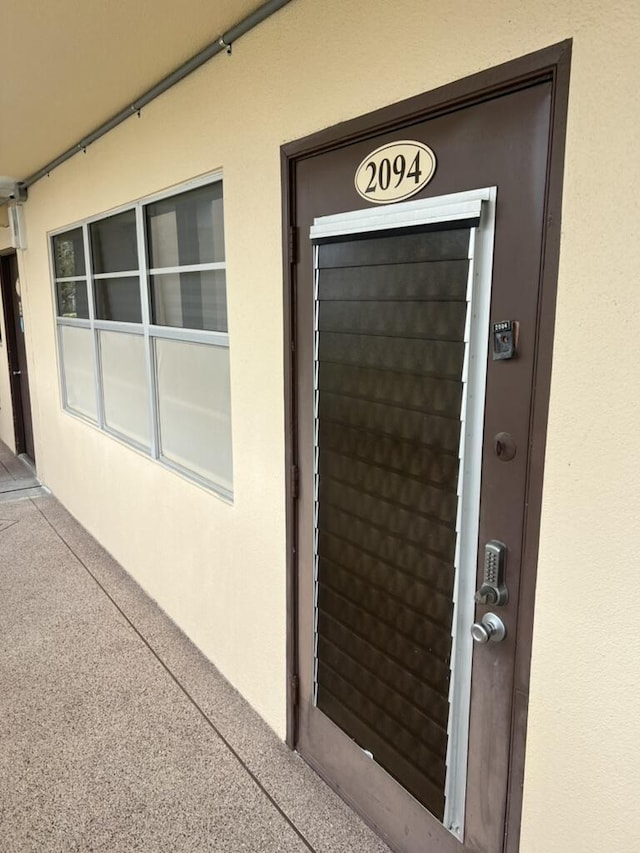 property entrance with stucco siding