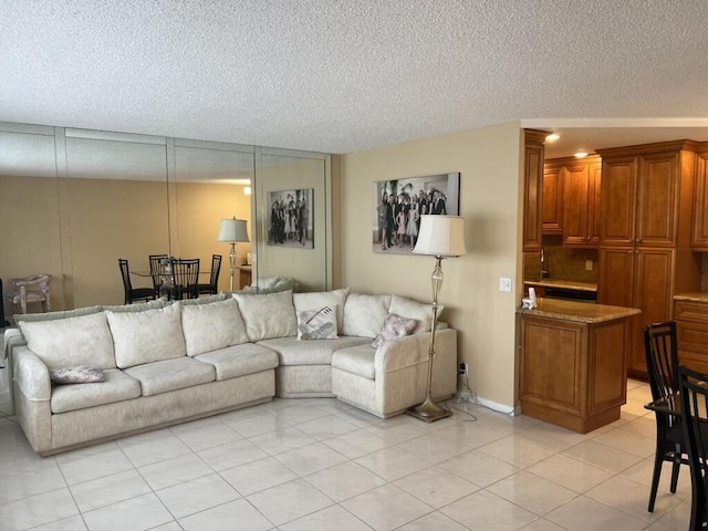 living area featuring light tile patterned floors and a textured ceiling