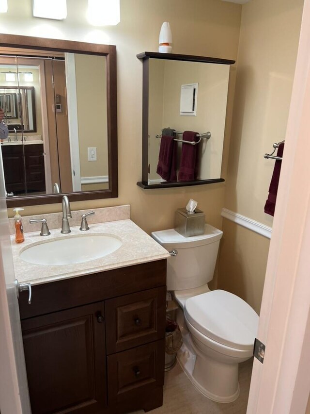 bathroom featuring toilet and vanity