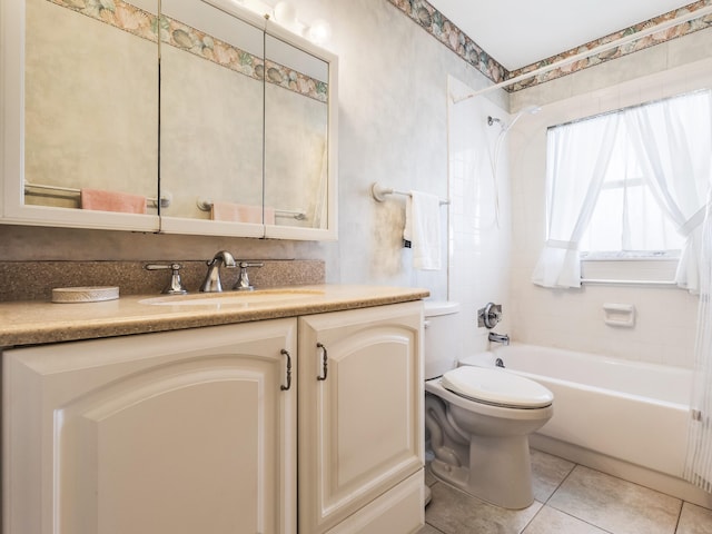 bathroom featuring tile patterned floors, vanity, toilet, and washtub / shower combination