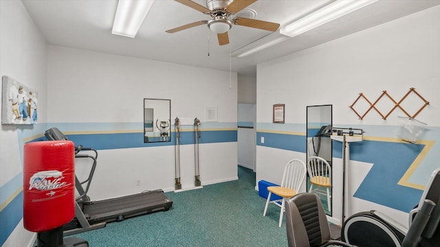 exercise room with carpet and a ceiling fan