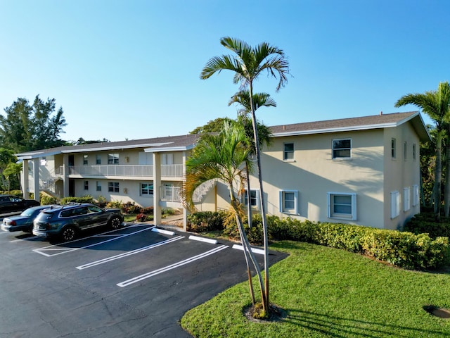 view of property featuring uncovered parking