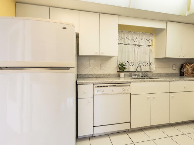 kitchen featuring white appliances, light countertops, tasteful backsplash, and a sink