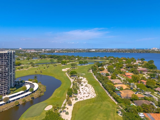 drone / aerial view with golf course view and a water view