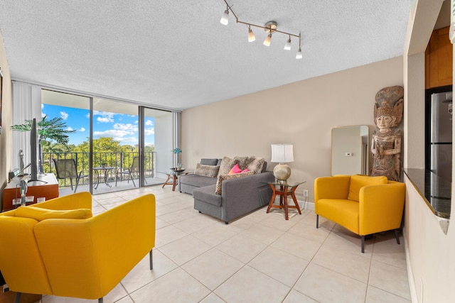 living area featuring floor to ceiling windows, light tile patterned floors, baseboards, and a textured ceiling