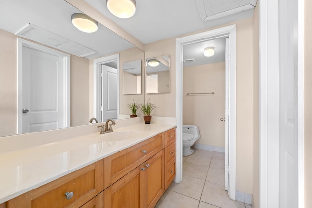 bathroom with vanity, tile patterned floors, toilet, and baseboards