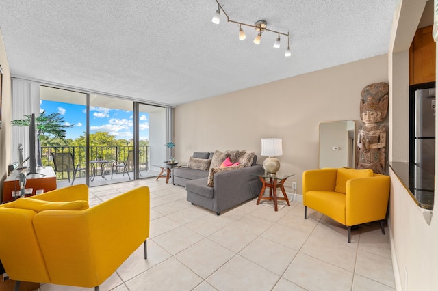 living area featuring light tile patterned floors, a textured ceiling, and floor to ceiling windows