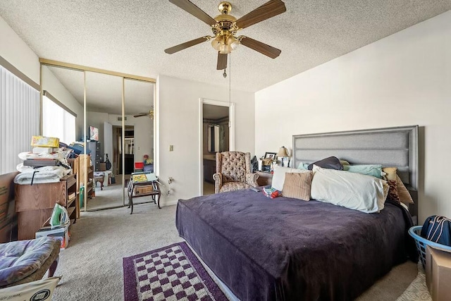 carpeted bedroom featuring a textured ceiling, a ceiling fan, and a closet