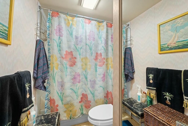 bathroom with a shower with curtain and toilet