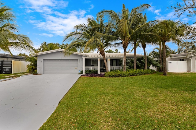 ranch-style home with a garage, driveway, a front lawn, and fence