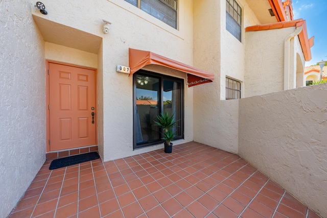 doorway to property featuring stucco siding