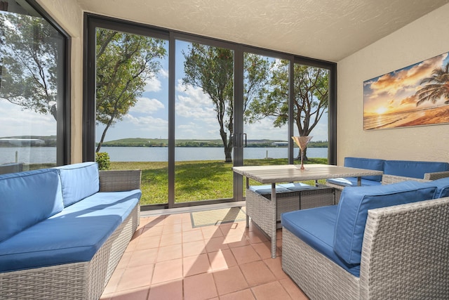 sunroom / solarium featuring a water view