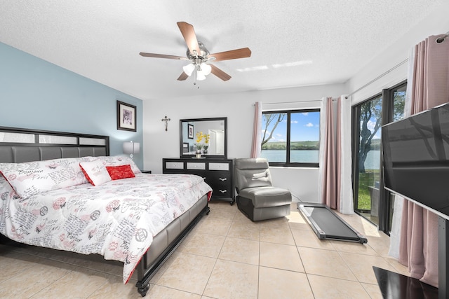 bedroom with light tile patterned flooring, a textured ceiling, a ceiling fan, and access to outside