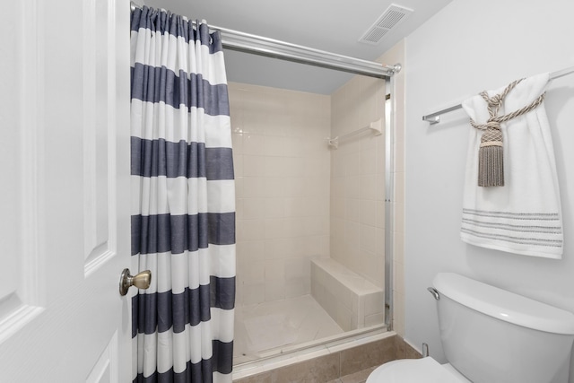 full bath with a shower stall, toilet, and visible vents