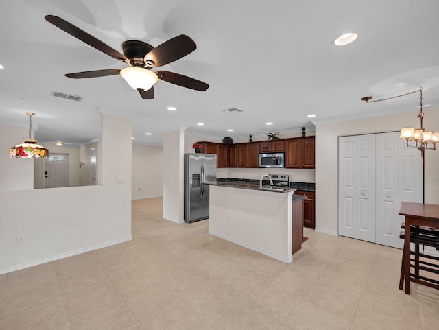 2185 SW Rockport Rd, Port Saint Lucie, FL 34953 - kitchen with ornamental molding, dark countertops, visible vents, and appliances with stainless steel finishes